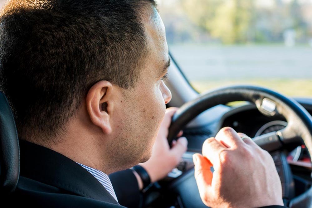 A chauffeur driving a car