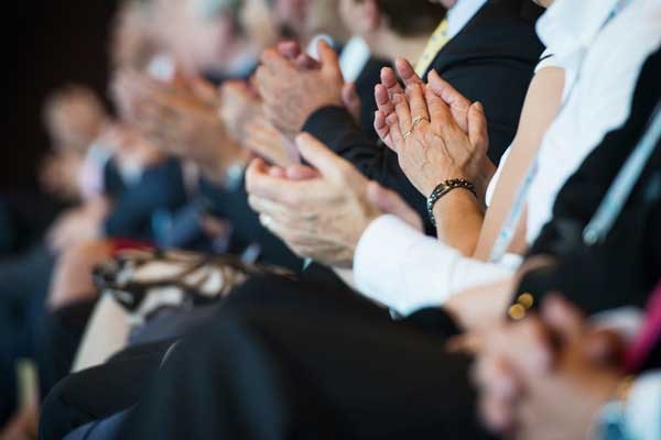 Audience members applauding